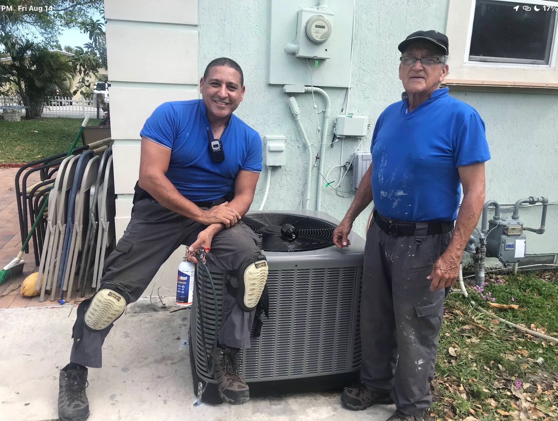 Lyos Elite technicians beside a newly installed A/C condenser