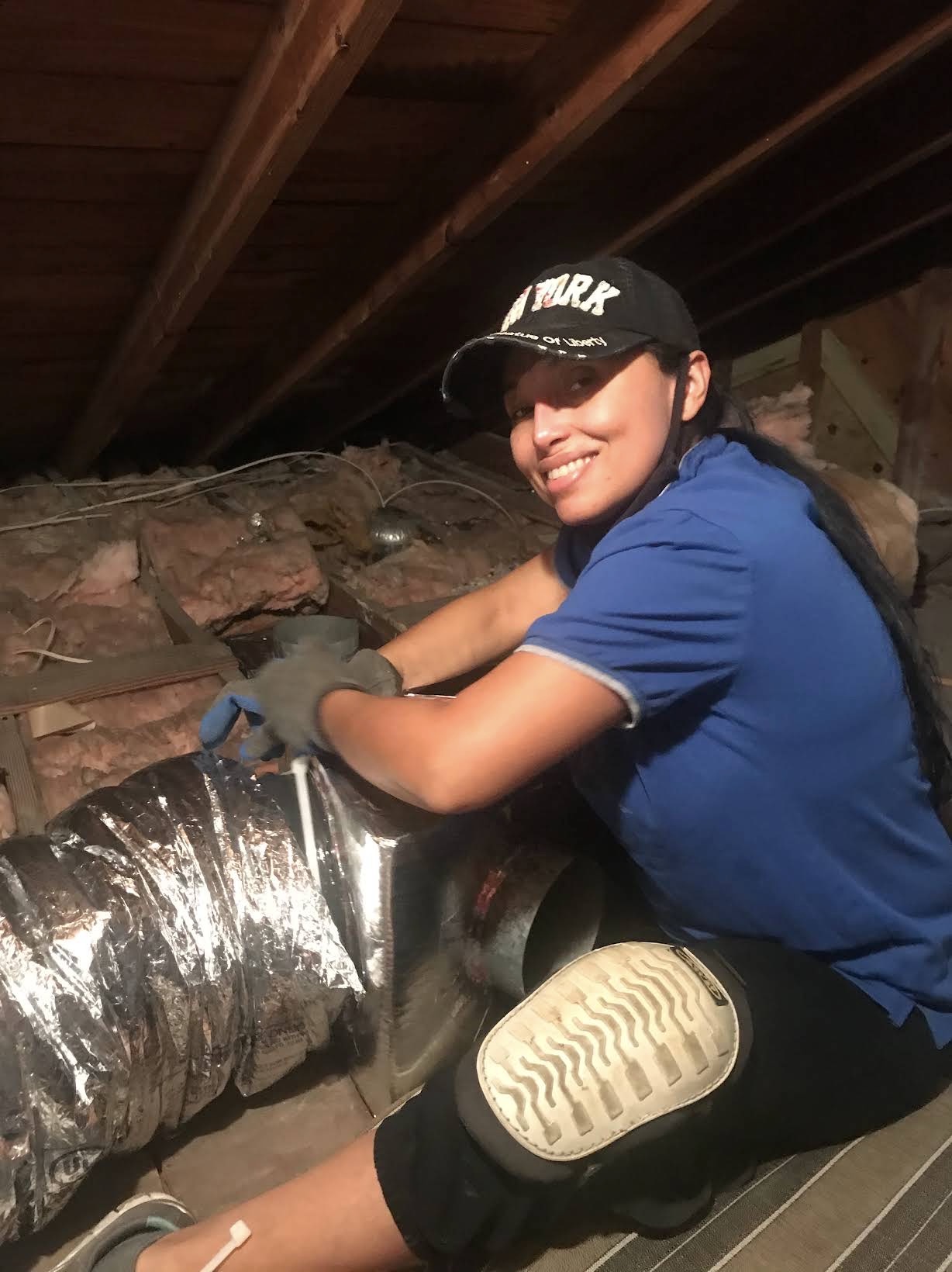 Lyos Elite technician connecting flex duct in an attic