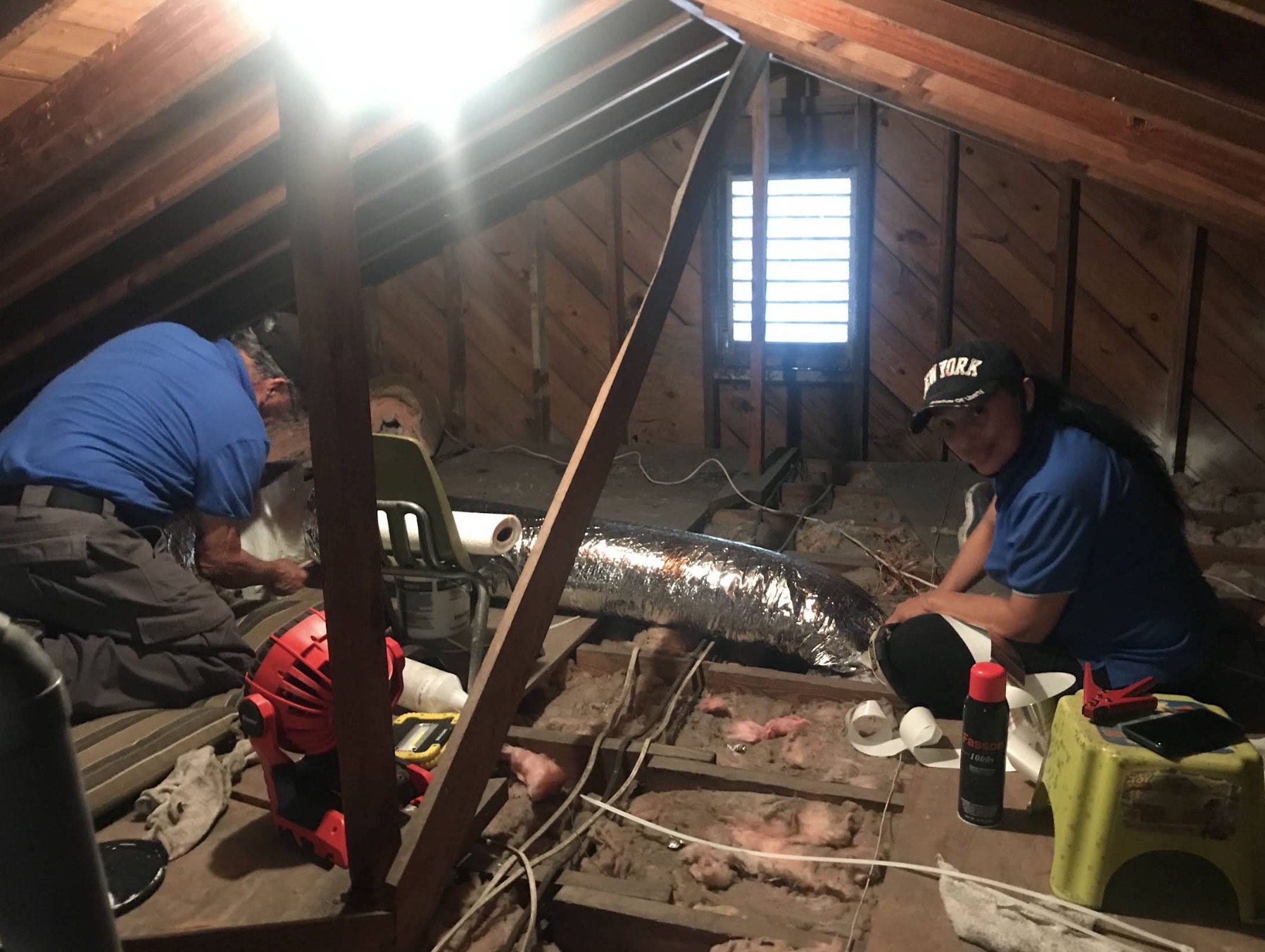 Lyos Elite crew running new flex duct in an attic