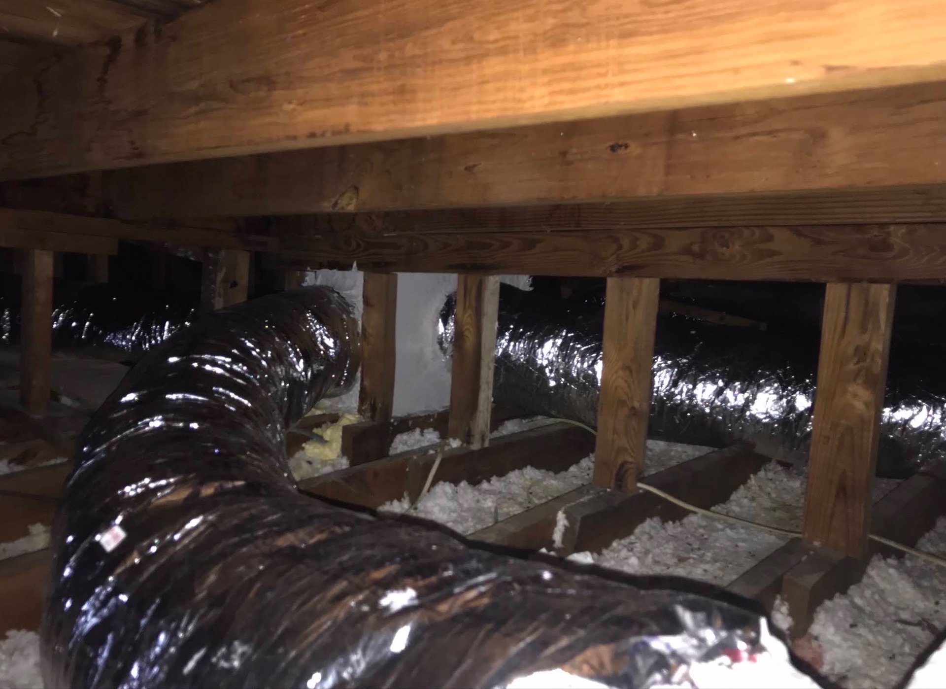 Duct system routed through an attic crawl space