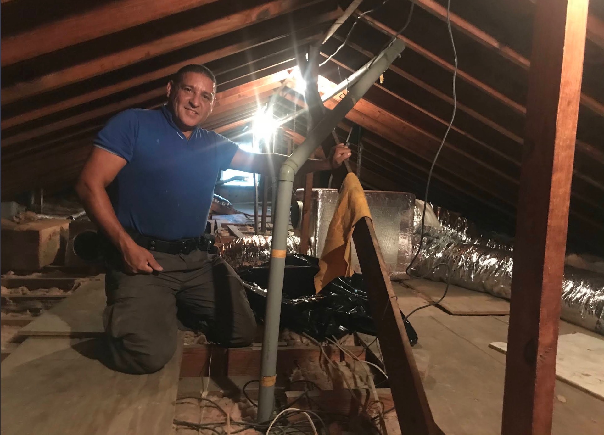 Technician working on duct work in a customer attic