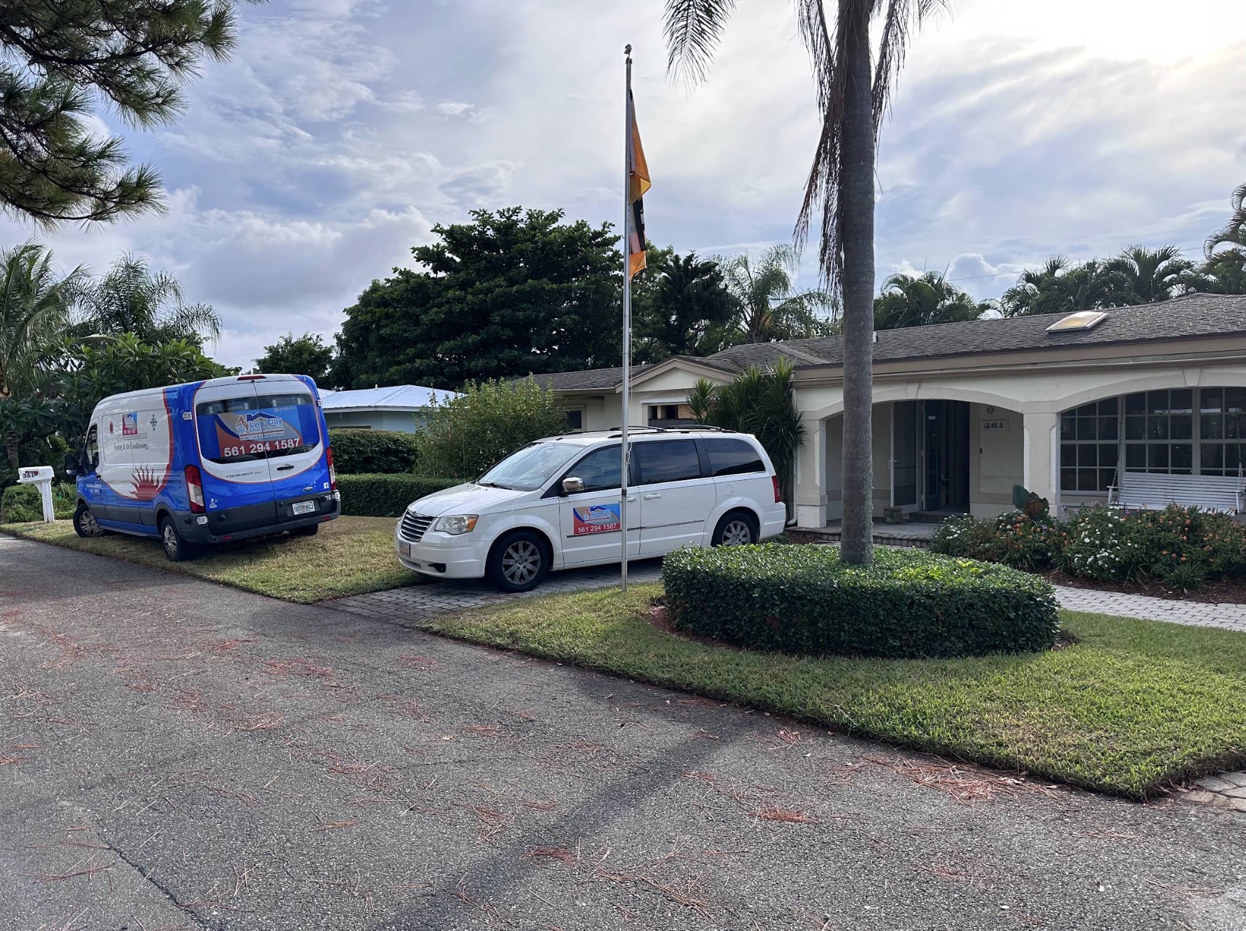 Lyos Elite service van and truck parked at a Palm Beach County home